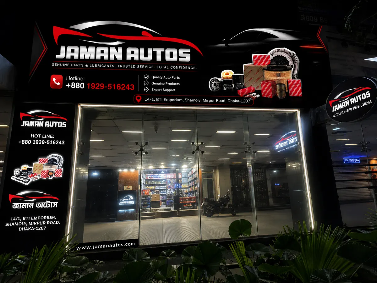 Jaman Autos illuminated storefront at night in Shyamoli, Dhaka